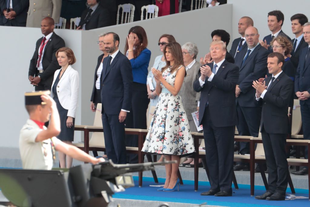 Trump watches a parade in France.