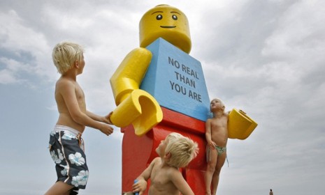 Children play with a giant Lego man that was fished out of the sea near a Dutch resort in 2007