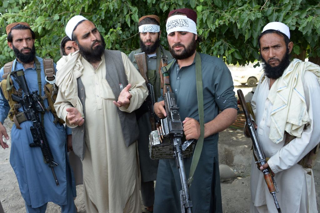 Taliban fighters and Afghan citizens during a recent 3-day truce.