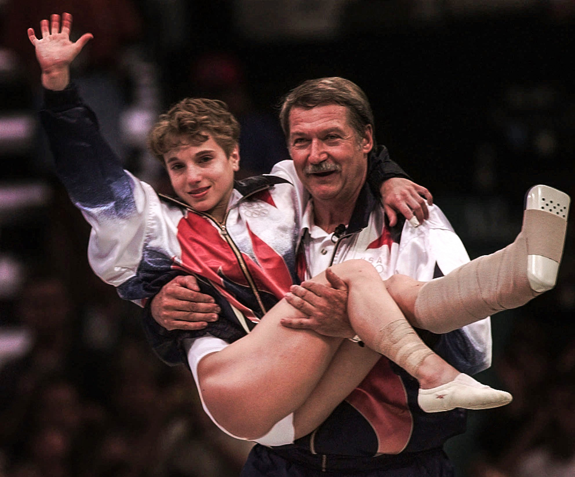 Kerri Strug is carried by her coach, Bela Karolyi, during the 1996 Olympics.