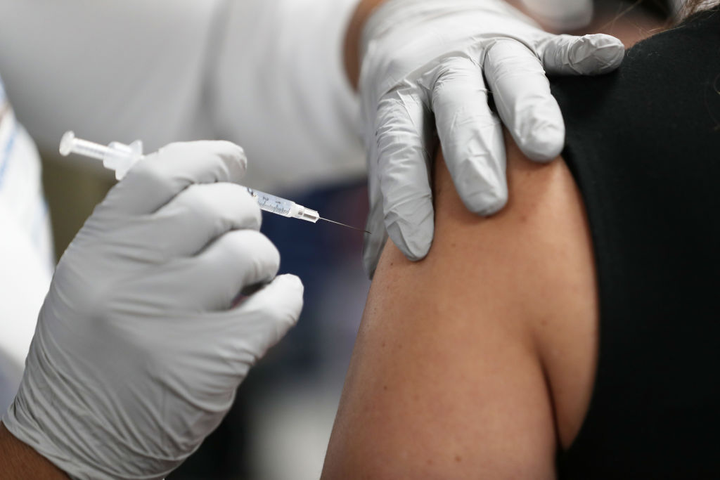 A healthcare worker at the Jackson Health Systems receives a Pfizer-BioNtech Covid-19 vaccine