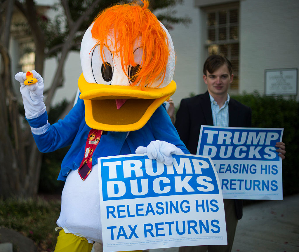 A protester demands the release of President Trump&#039;s tax returns