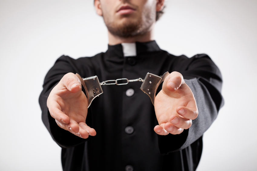 Pastor in handcuffs.