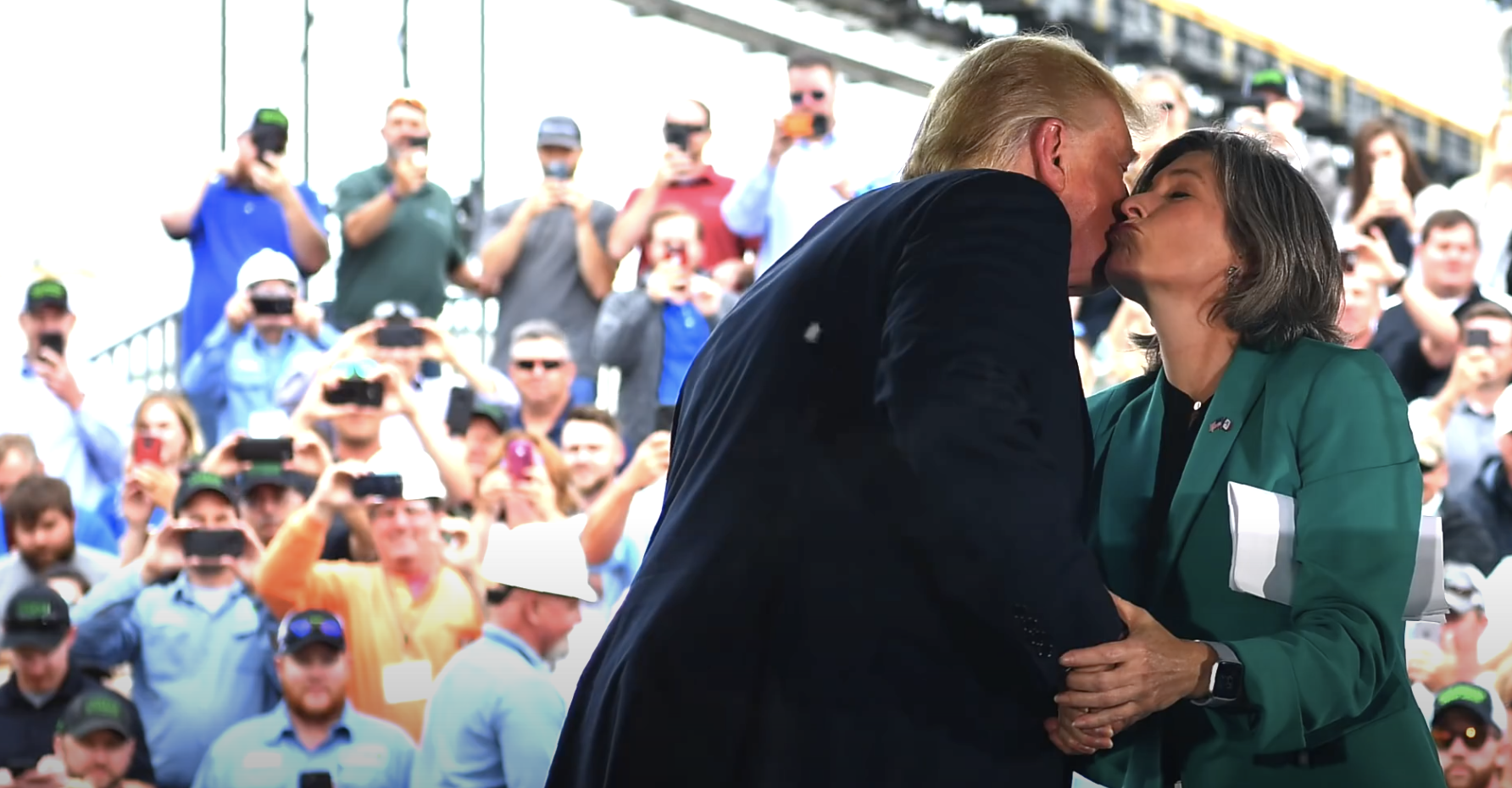President Trump kisses Sen. Joni Ernst on the cheek.