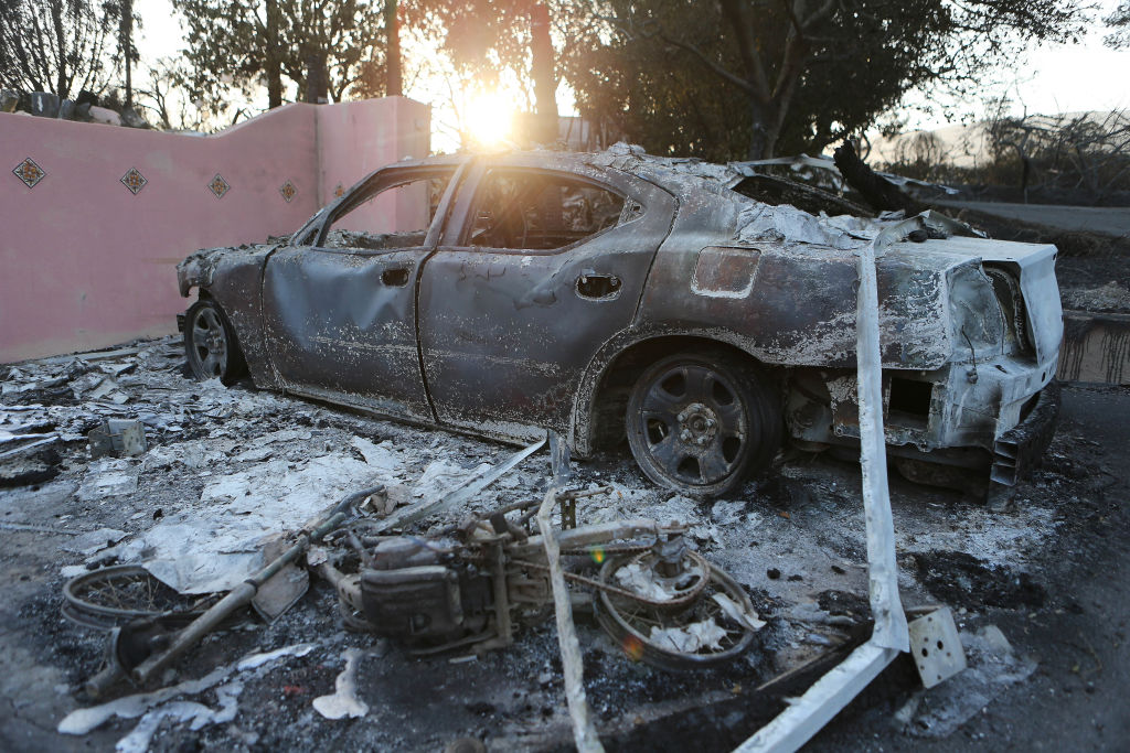 The remains of a car stand in front of a destroyed home in the aftermath of the Holiday Fire on July 7, 2018 in Goleta, California. 