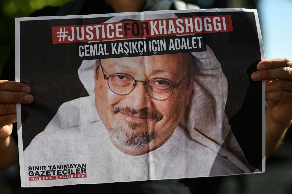A person holds a picture of Jamal Khashoggi.