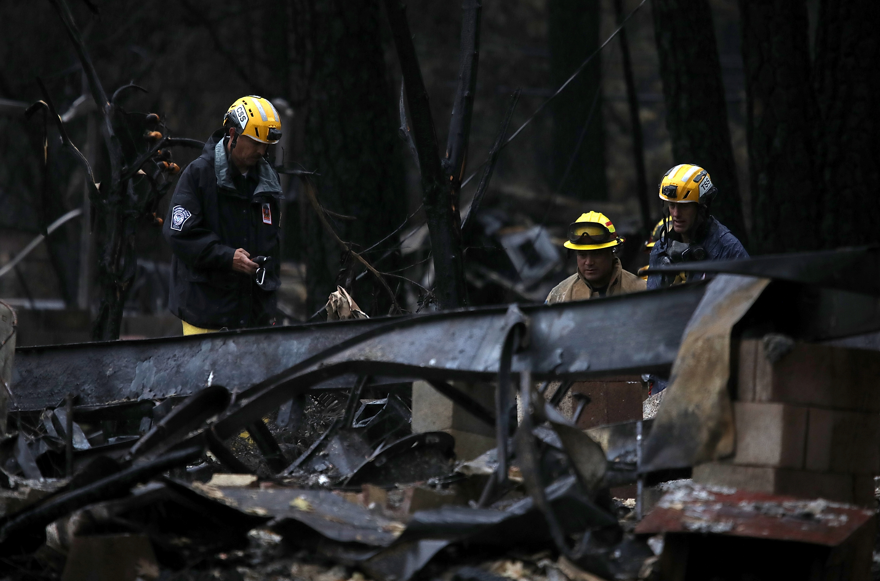  Search and rescue crews search a property that was destroyed by the Camp Fire for human remains on November 22, 2018 in Paradise, California.