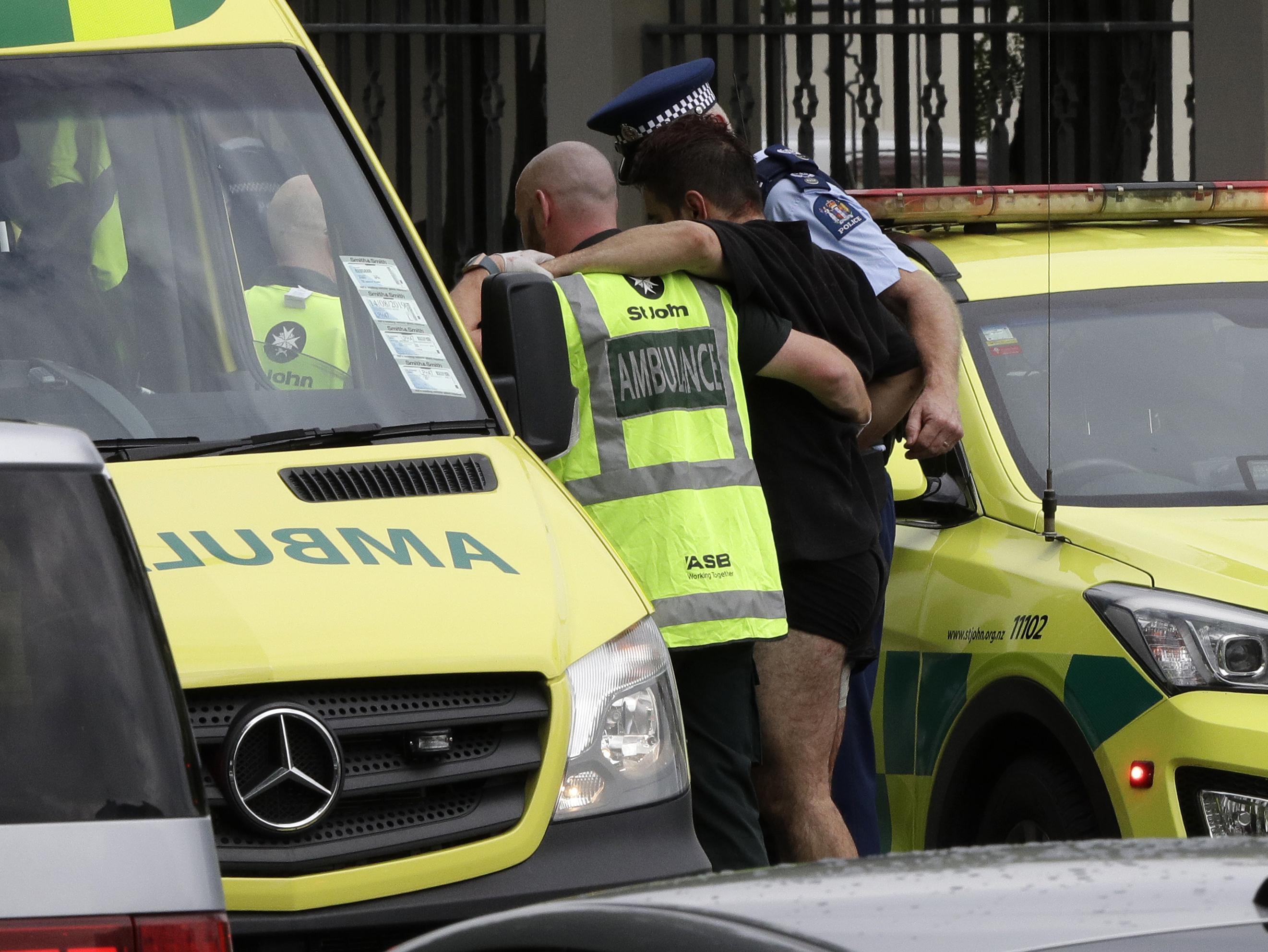 First responders help a man injured during a shooting in Christchurch.
