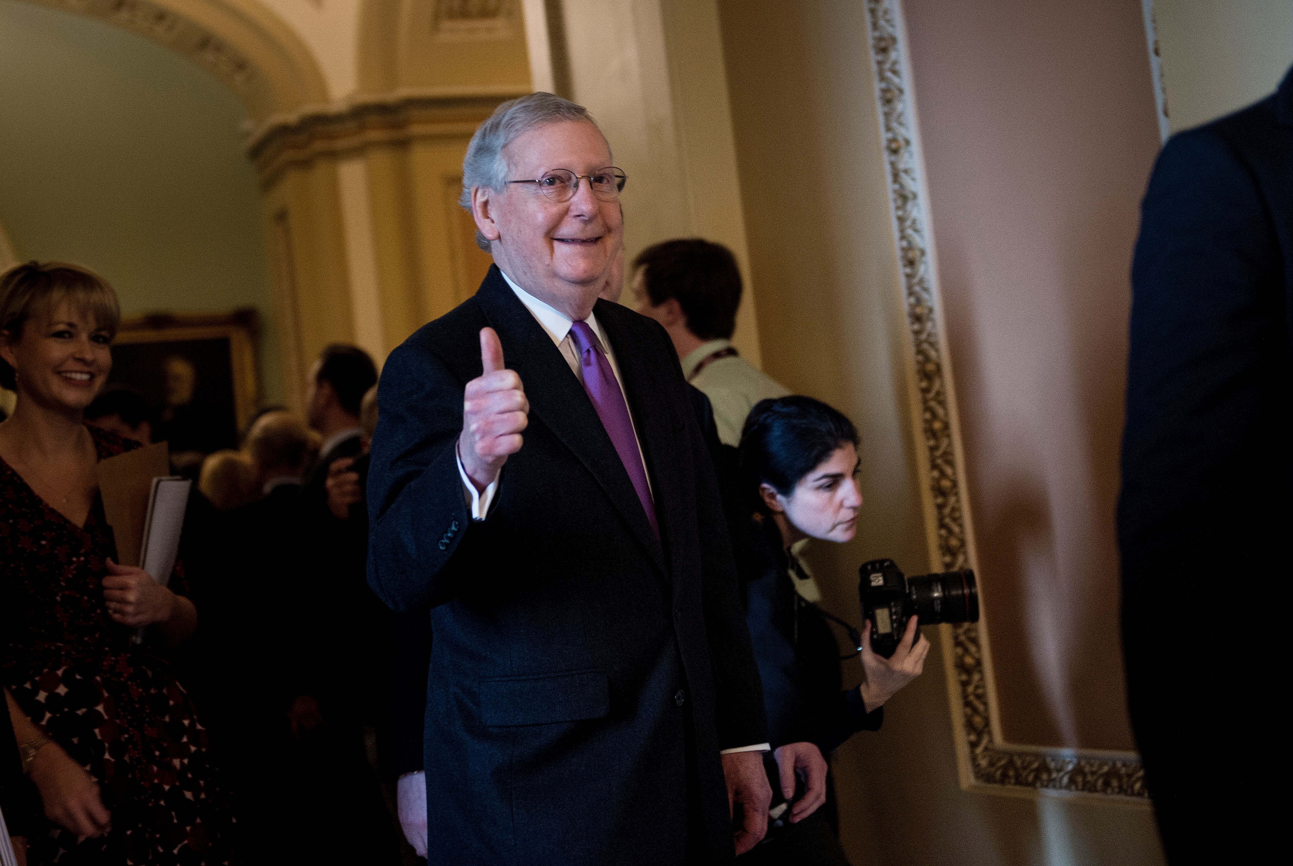 Mitch McConnell gives a thumbs up after a vote on Capitol Hill