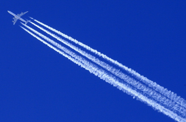 A commercial airline leaves behind contrails.