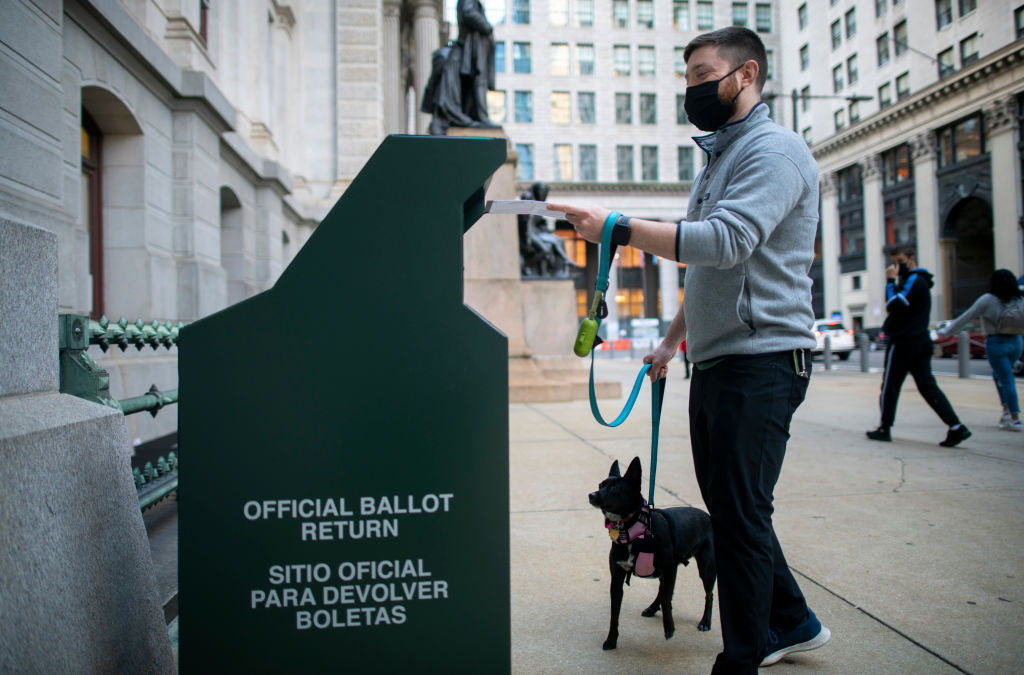 A man drops off his ballot in Philadelphia.