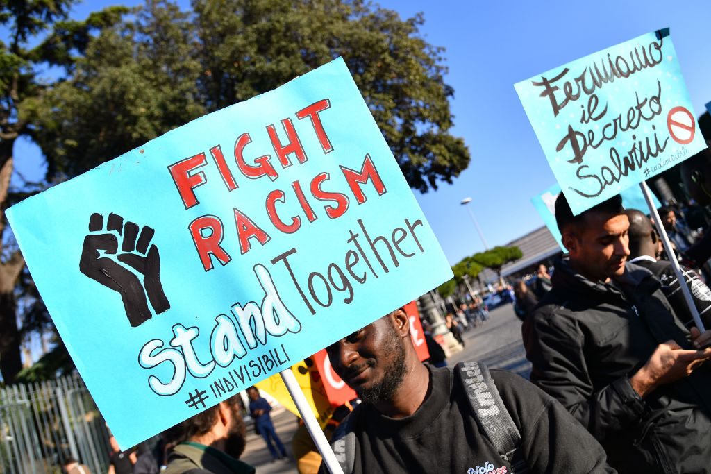 A poster reads &quot;fight racism&quot;