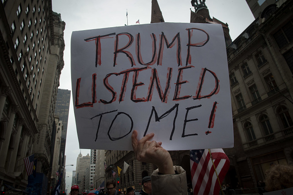 A Trump supporter holds up a sign at a rally outside Trump Tower.