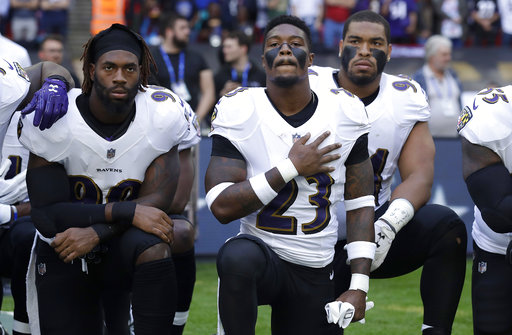 Baltimore Ravens players kneel during the national anthem in London