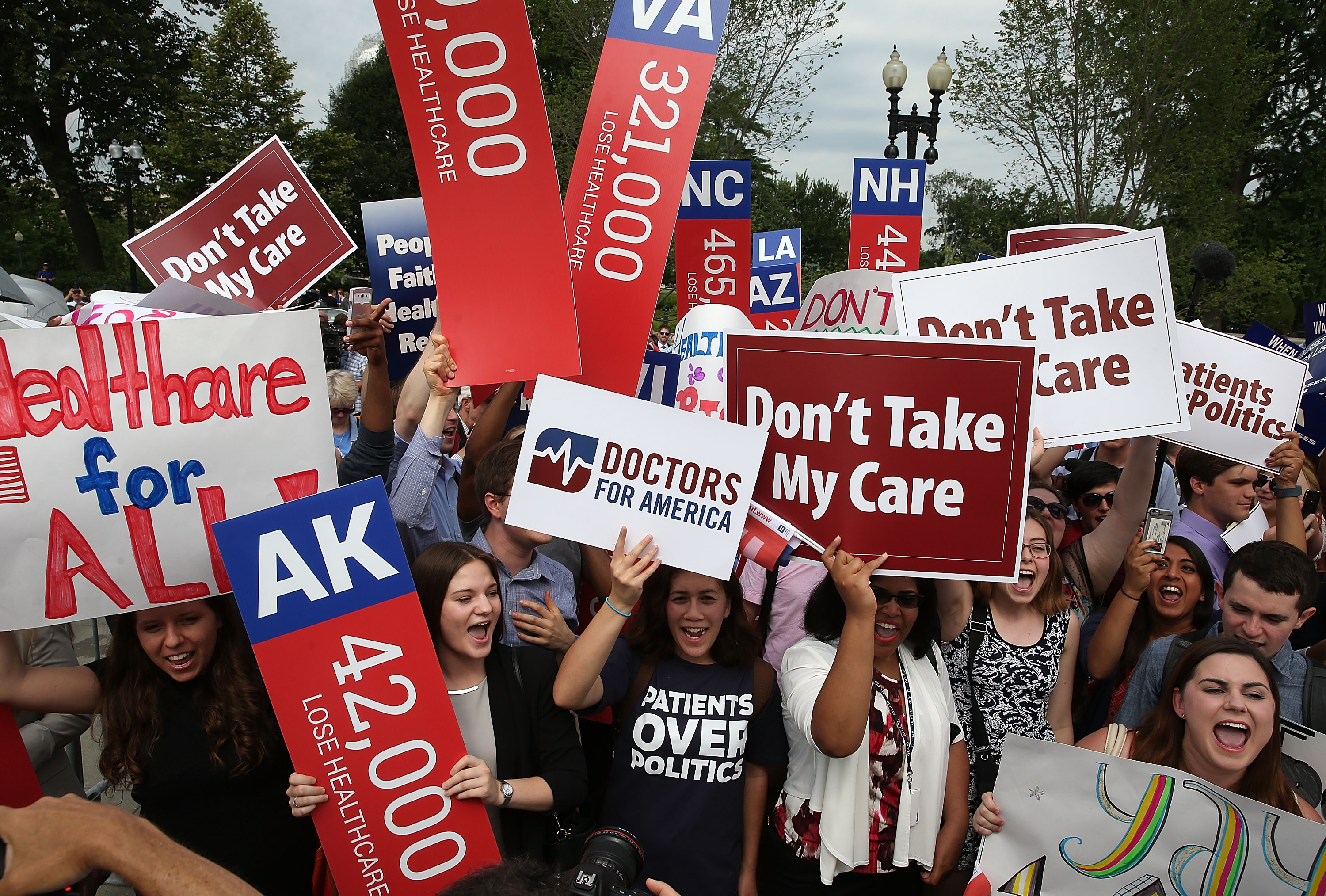 ObamaCare supporters cheer in front of the Supreme Court building