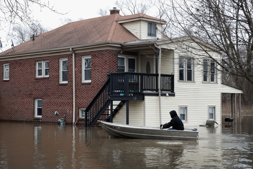  A resident uses a rowboat to navigate a flooded neighborhood on February 22, 2018 in Lake Station, Indiana. 