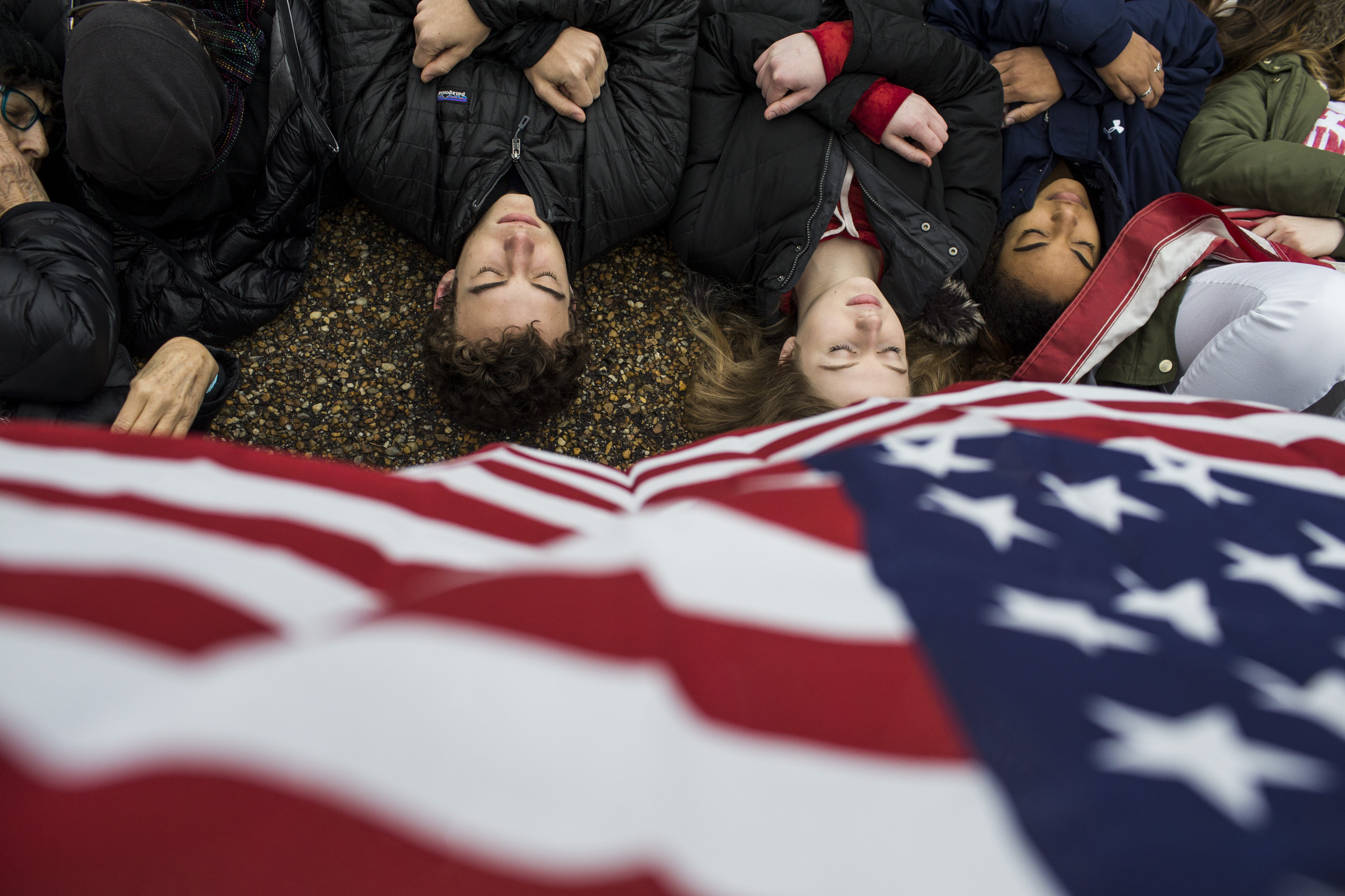 Demonstrators lie down to represent students killed in a recent school shooting