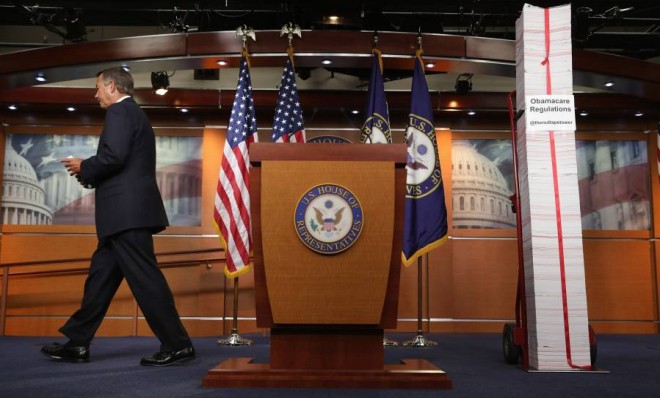 Speaker of the House John Boehner (R-Ohio) walks away from the podium and from a printed version of ObamaCare after a news conference on May 16.