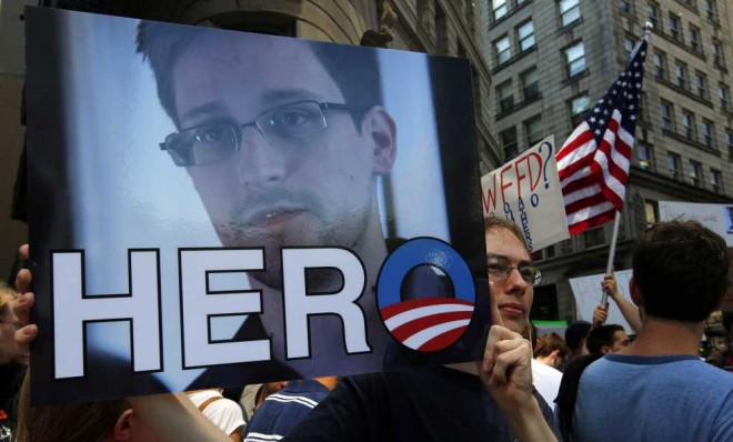 A demonstrator holds a Snowden sign during Fourth of July celebration in Boston.