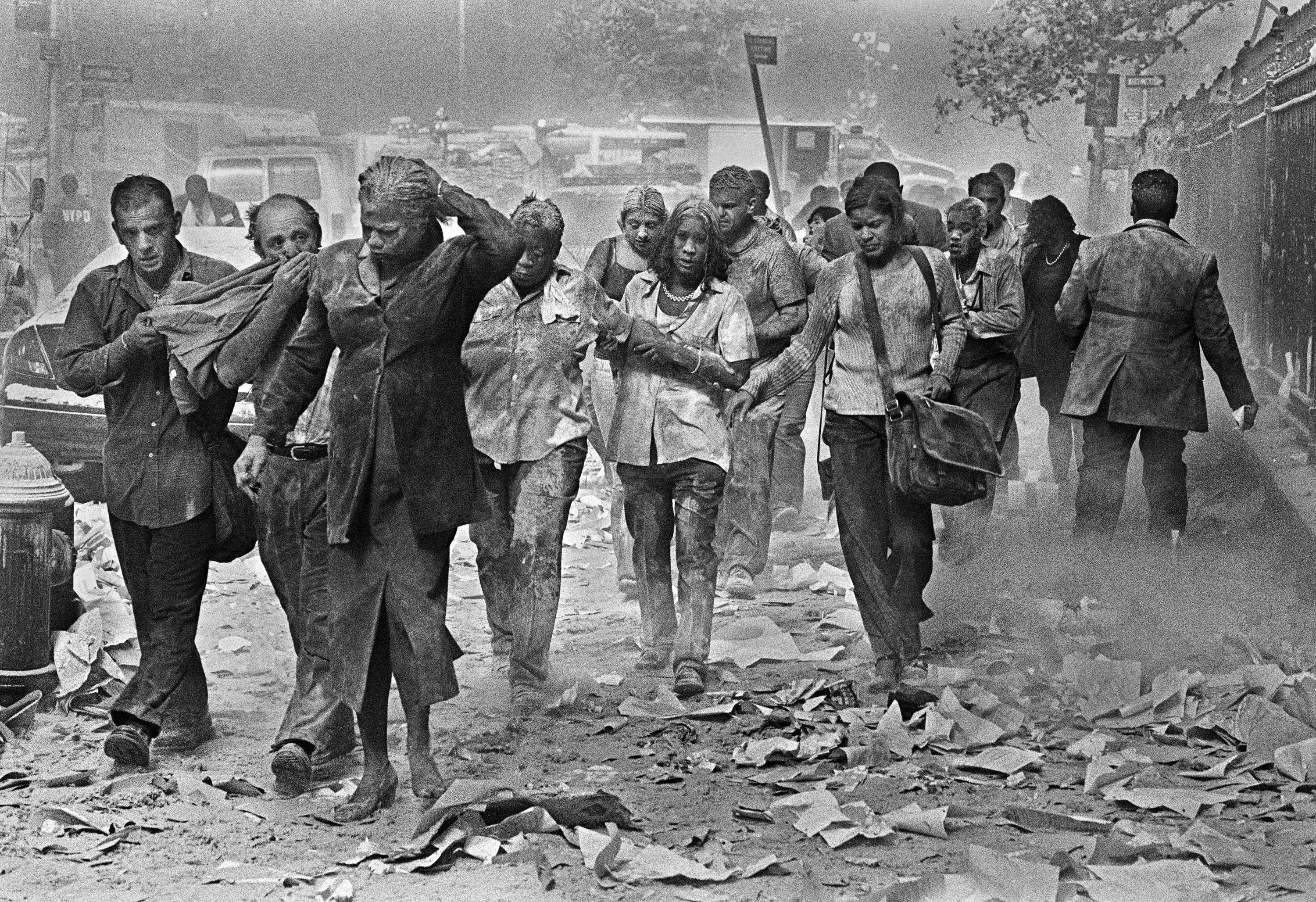 Survivors of the September 11 attacks make their way through smoke, dust, and debris.