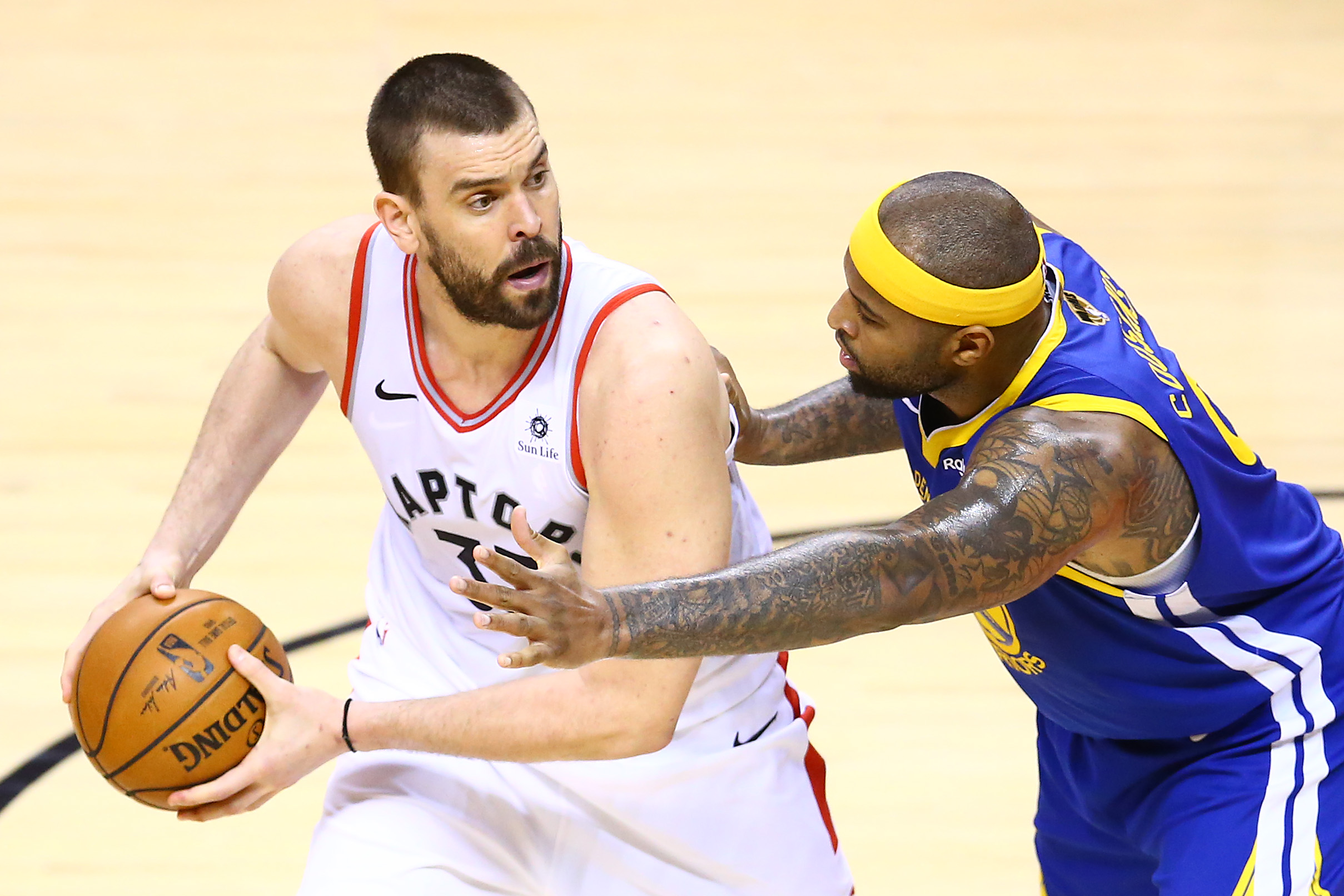 Marc Gasol #33 of the Toronto Raptors (left) and DeMarcus Cousins #0 of the Golden State Warriors (right).