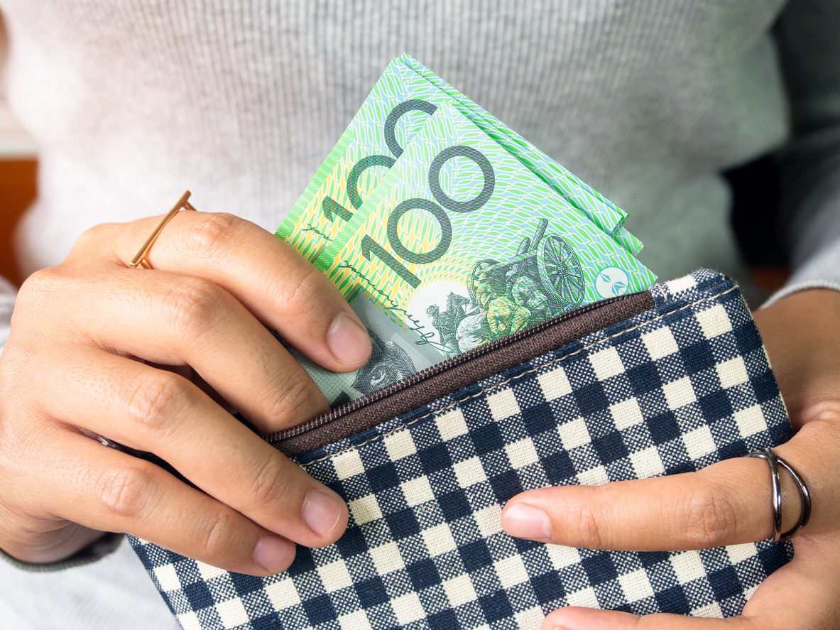 A person holds Australian money.