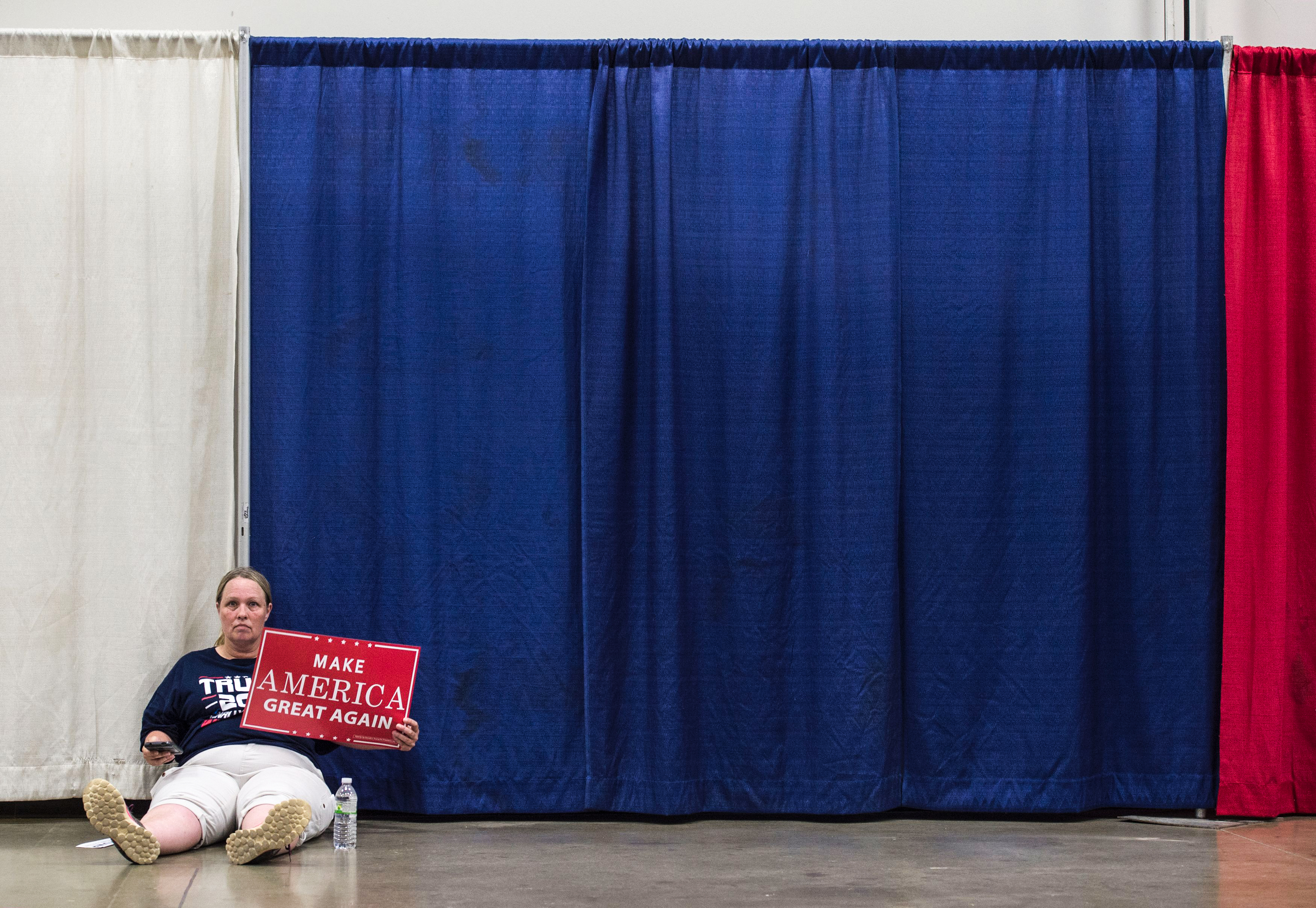 A Trump supporter waits for a rally to start. 
