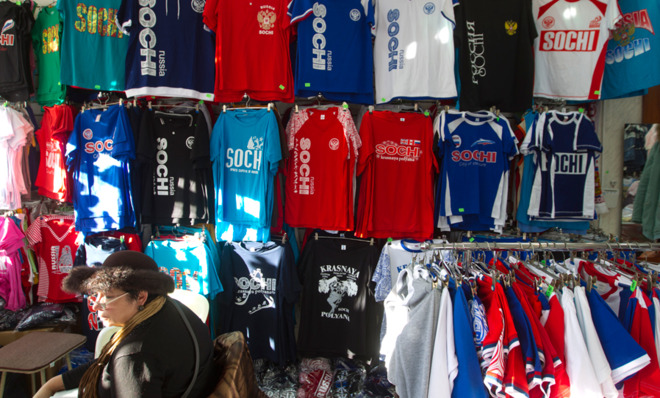 A woman sells souvenir t-shirts in a shop in Sochi on Dec. 30.  