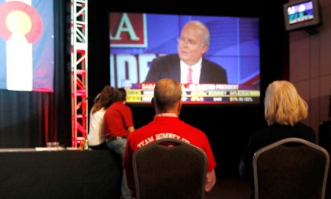 A couple watches Karl Rove on Fox News during a Republican Party election night gathering in Denver, Colo. 