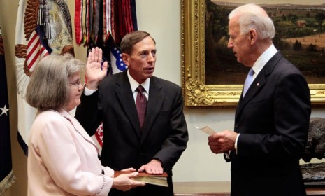 David Petraeus is sworn in as CIA Director while his wife, Holly Knowlton Petraeus holds the family bible on Sept. 6, 2011.