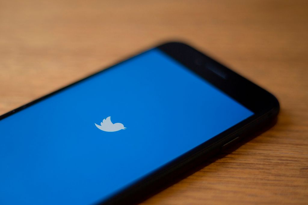 The Twitter logo is seen on a phone in this photo illustration in Washington, DC, on July 10, 2019.