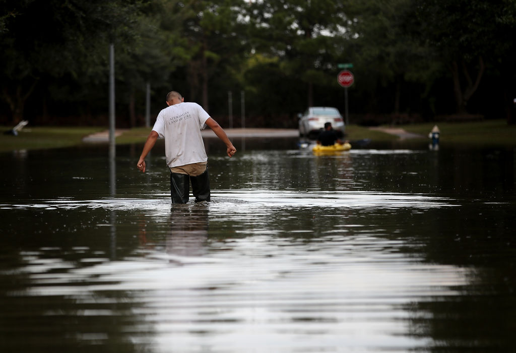 A man wades through flood waters from Tropical Storm Harvey in Houston, Texas.