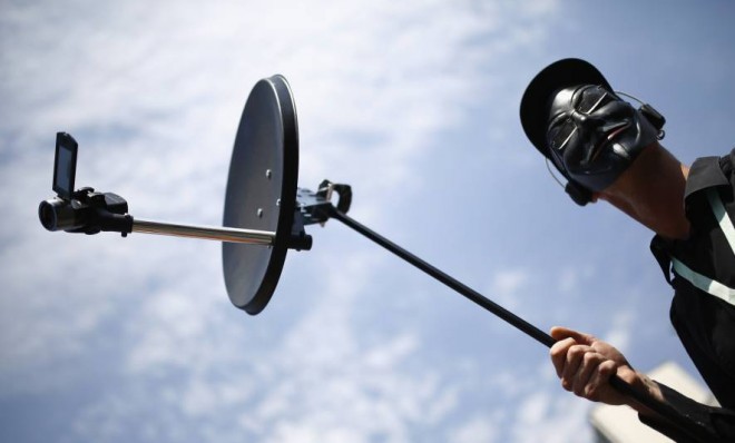 A protester holds a mock bugging device during a demonstration against the NSA in Frankfurt, Germany, on July 27.