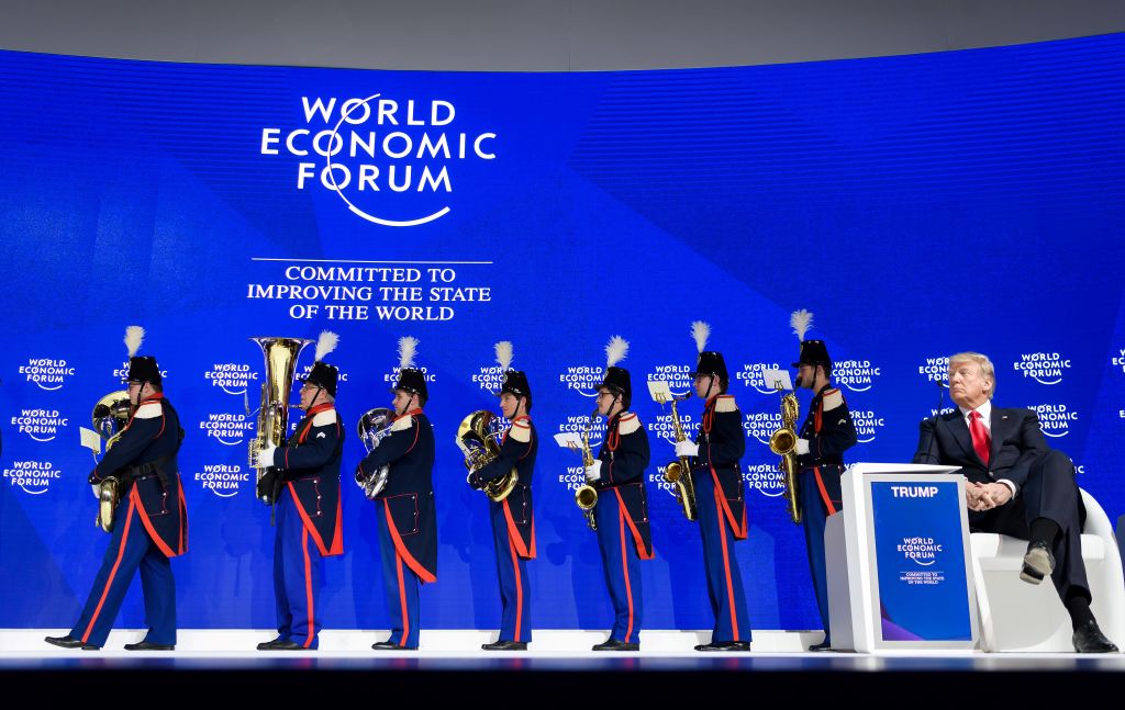 President Donald Trump looks on as the Landwehr Fribourg band leaves the stage during the World Economic Forum (WEF) annual meeting on January 26, 2018 in Davos, eastern Switzerland.