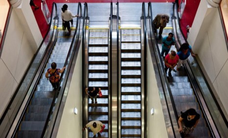 Shoppers in a New York City mall: Consumer spending fell in June for the first time in nearly two years, raising fears of a double-dip recession.