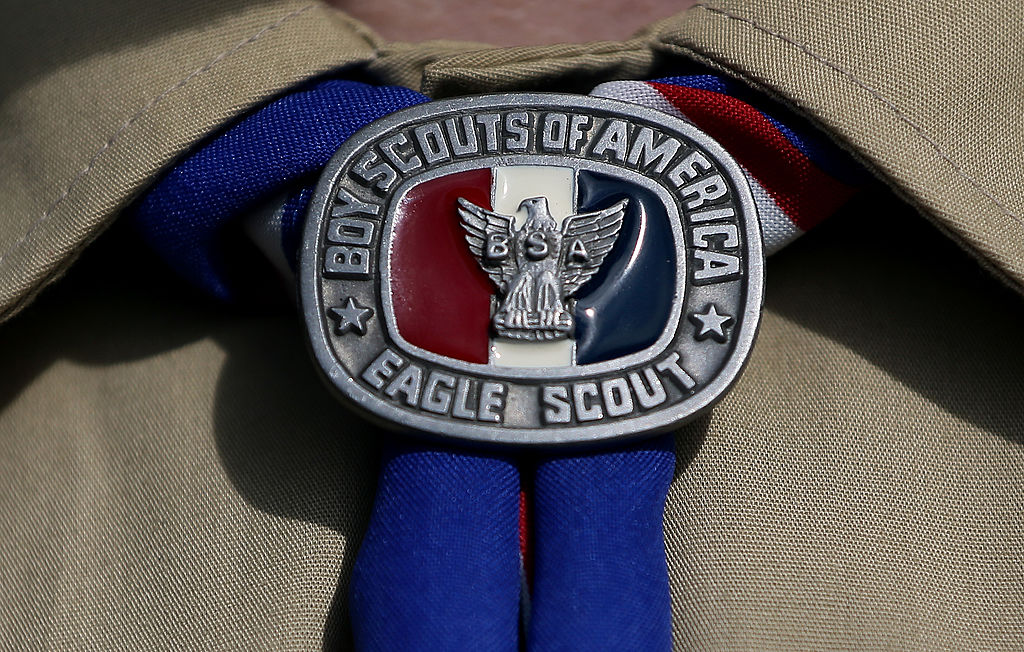 A Boy Scout wears an Eagle Scout medal.