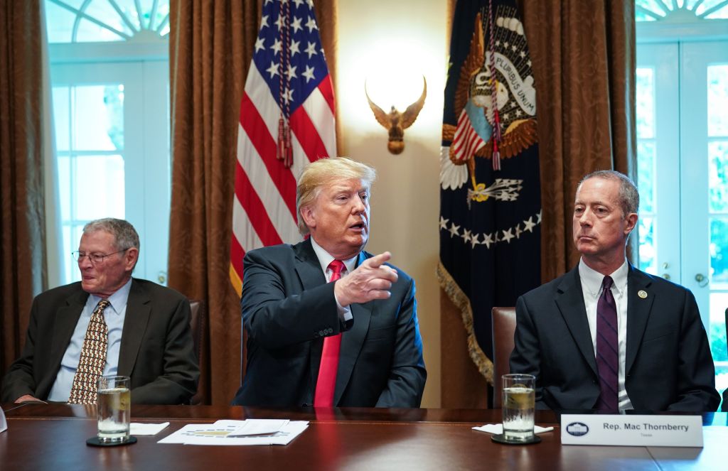 President Trump sits beside Republican Rep. Mac Thornberry of Texas and Jim Inhofe of Oklahoma