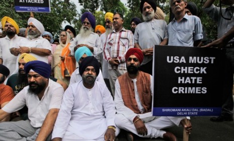 Indian Sikhs sit and pray in protest in New Delhi, India