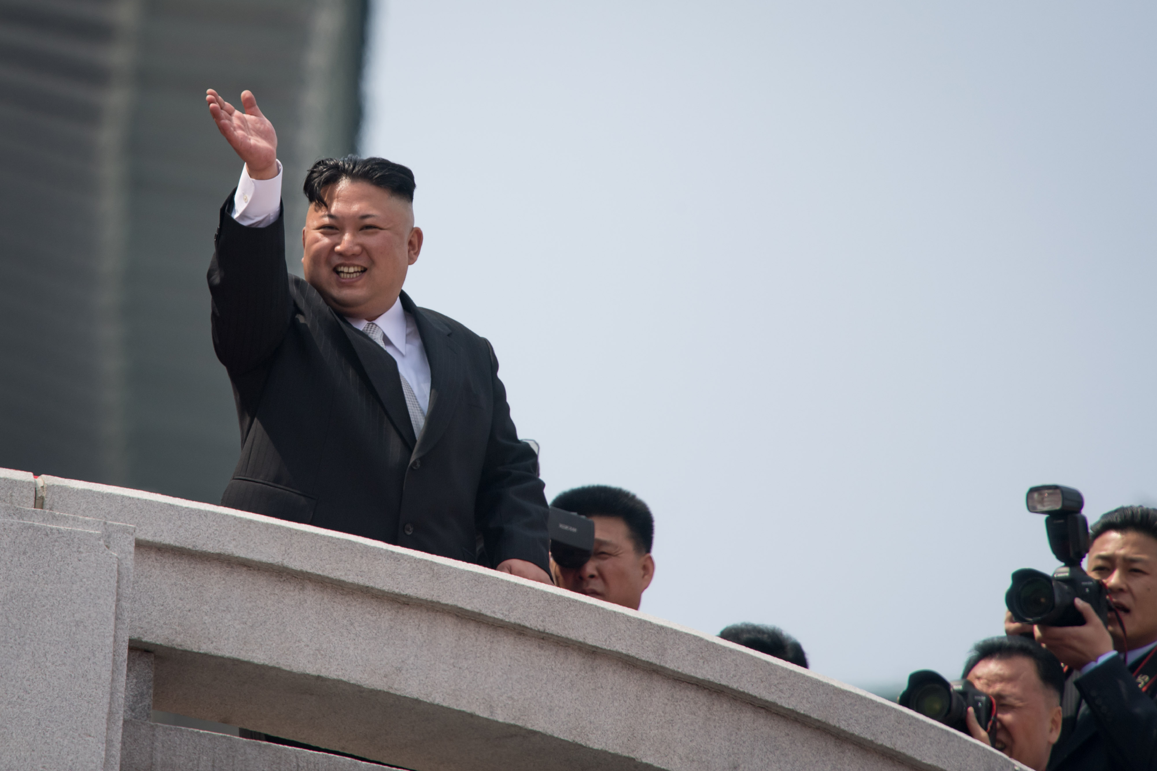 Kim Jong Un waves during a military parade