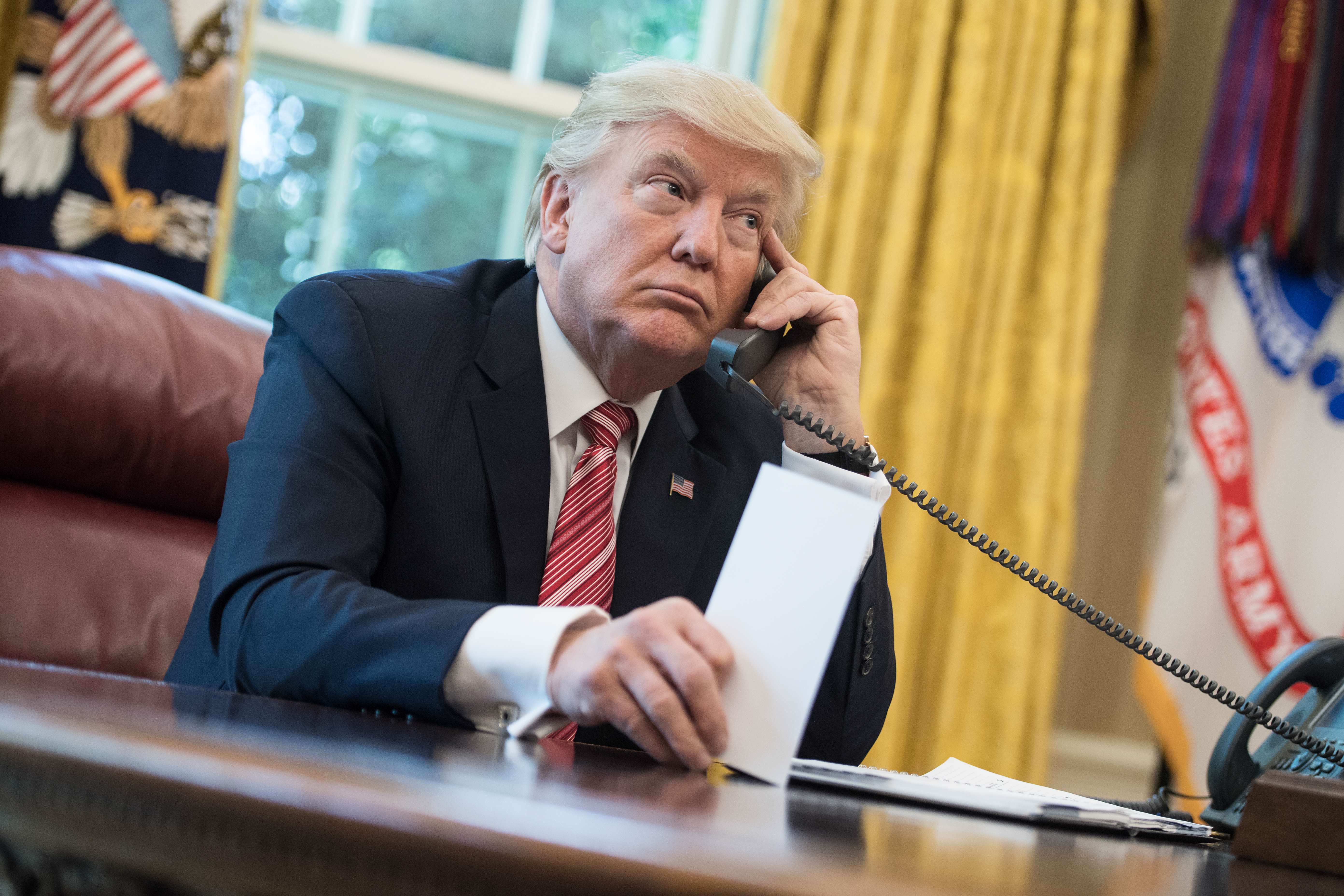 President Trump speaks on the phone in the Oval Office