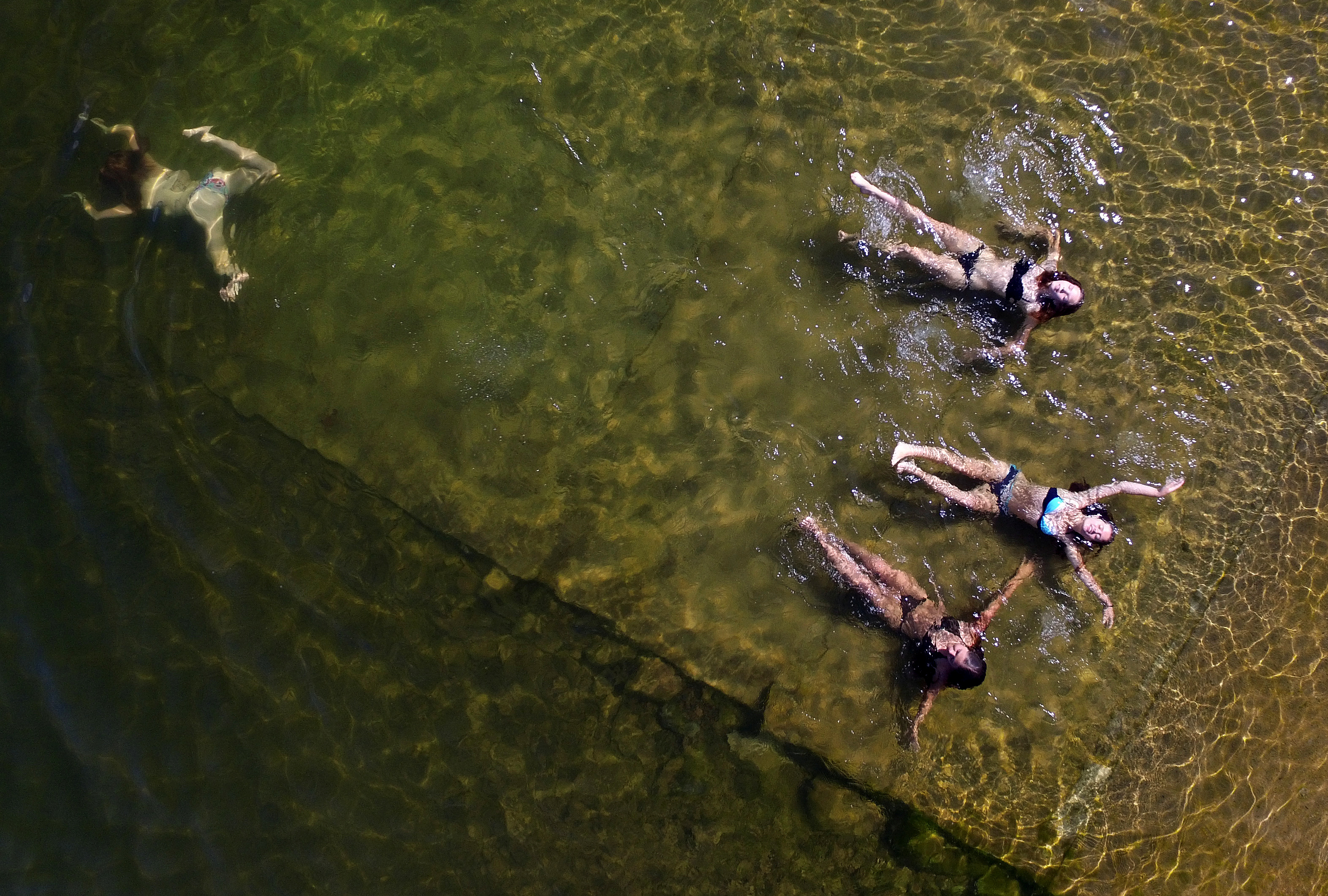 Women swim outside Krasnoyarsk, Siberia, Russia.