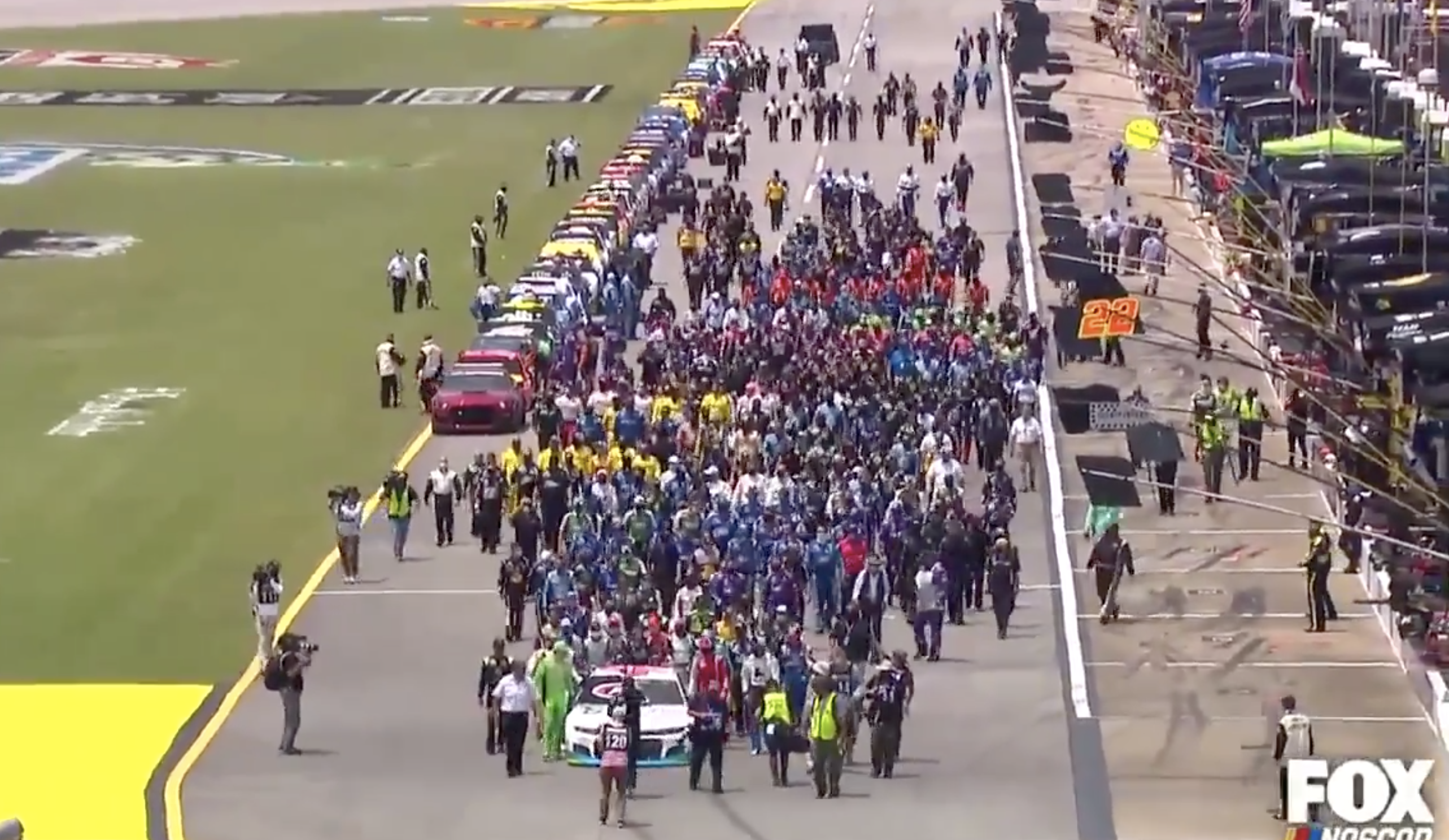 NASCAR drivers and crews march behind Bubba Wallaces car