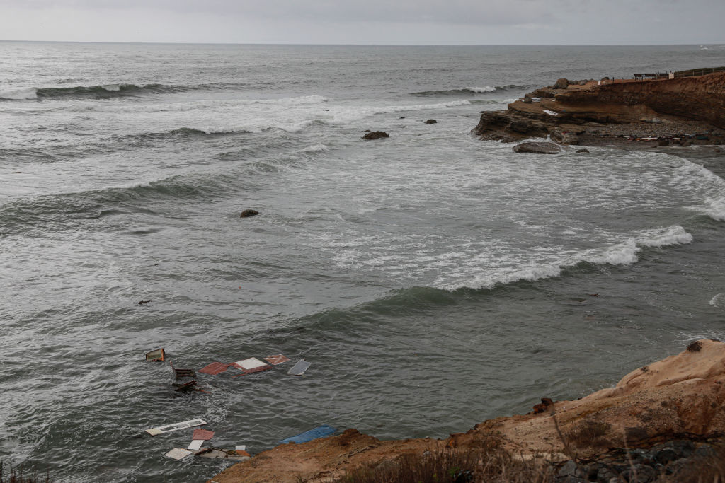 Debris floats off Point Loma after a suspected smuggling boat capsized.