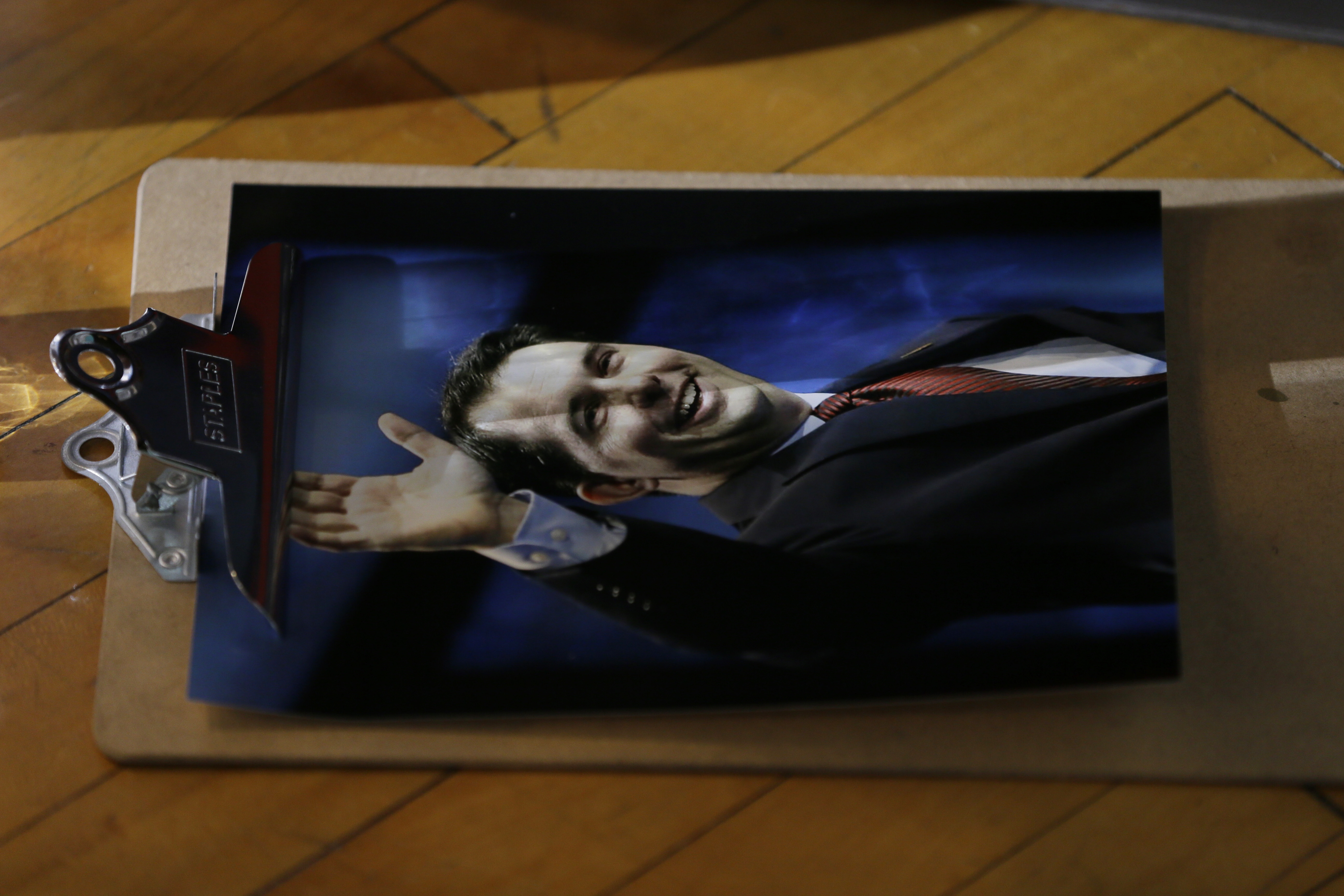 A photo of Scott Walker sits on the floor.