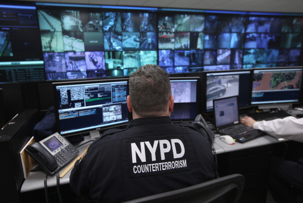 An NYPD officer looks at surveillance film.