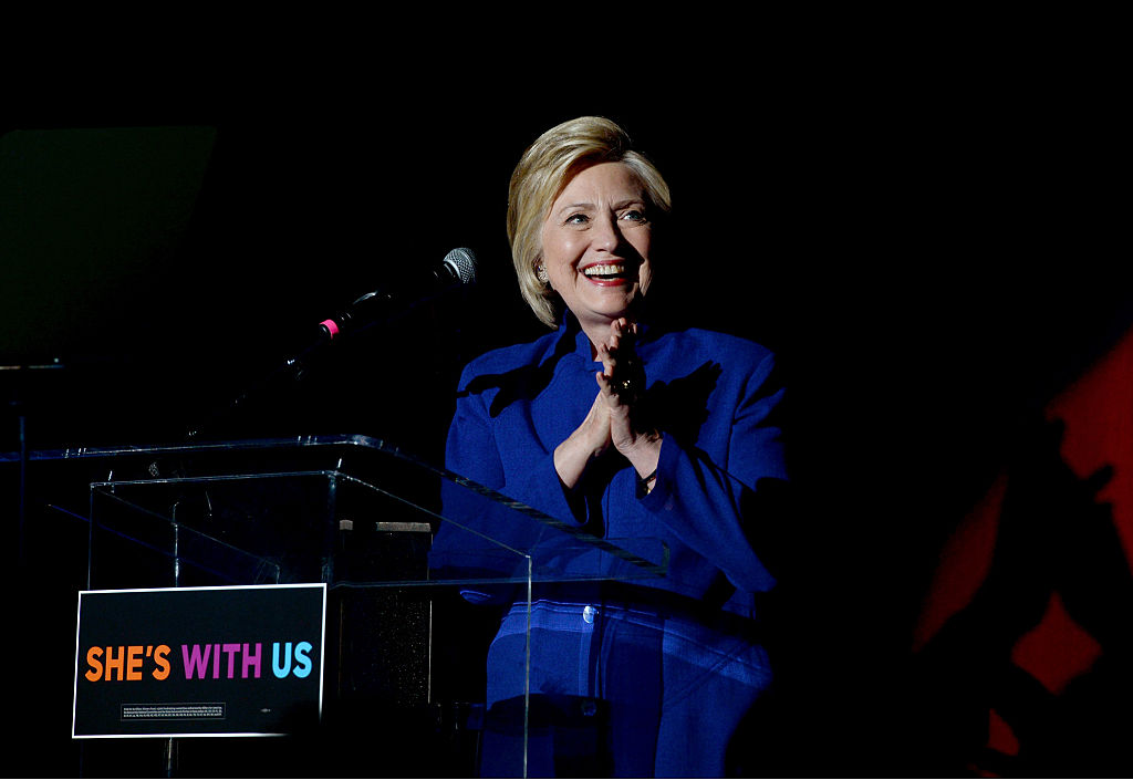 Hillary Clinton claps during a star-studded performance in her honor