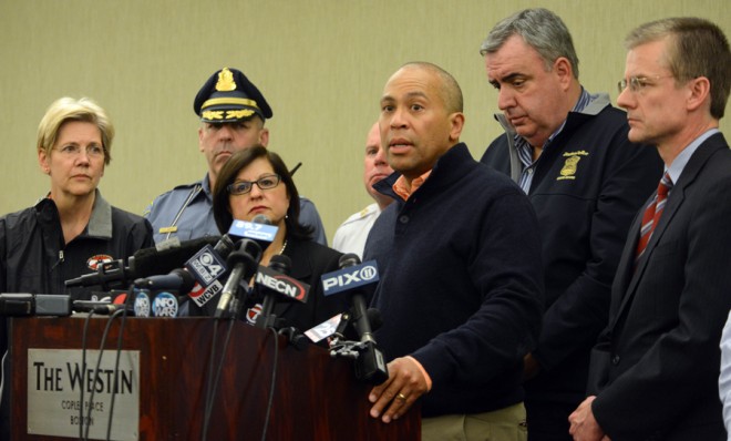 Massachusetts Gov. Deval Patrick is joined by FBI Special Agent Richard DesLauriers (far right) during a press conference on April 15.