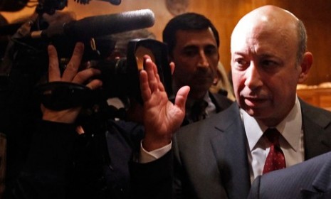 Goldman Sachs CEO Lloyd Blankfein fends off reporters after a federal hearing.