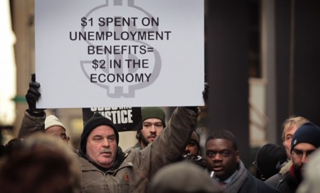Protesters in Chicago call for jobless benefit extensions just as November unemployment numbers reveal a jump from 9.6 to 9.8 percent nationwide.