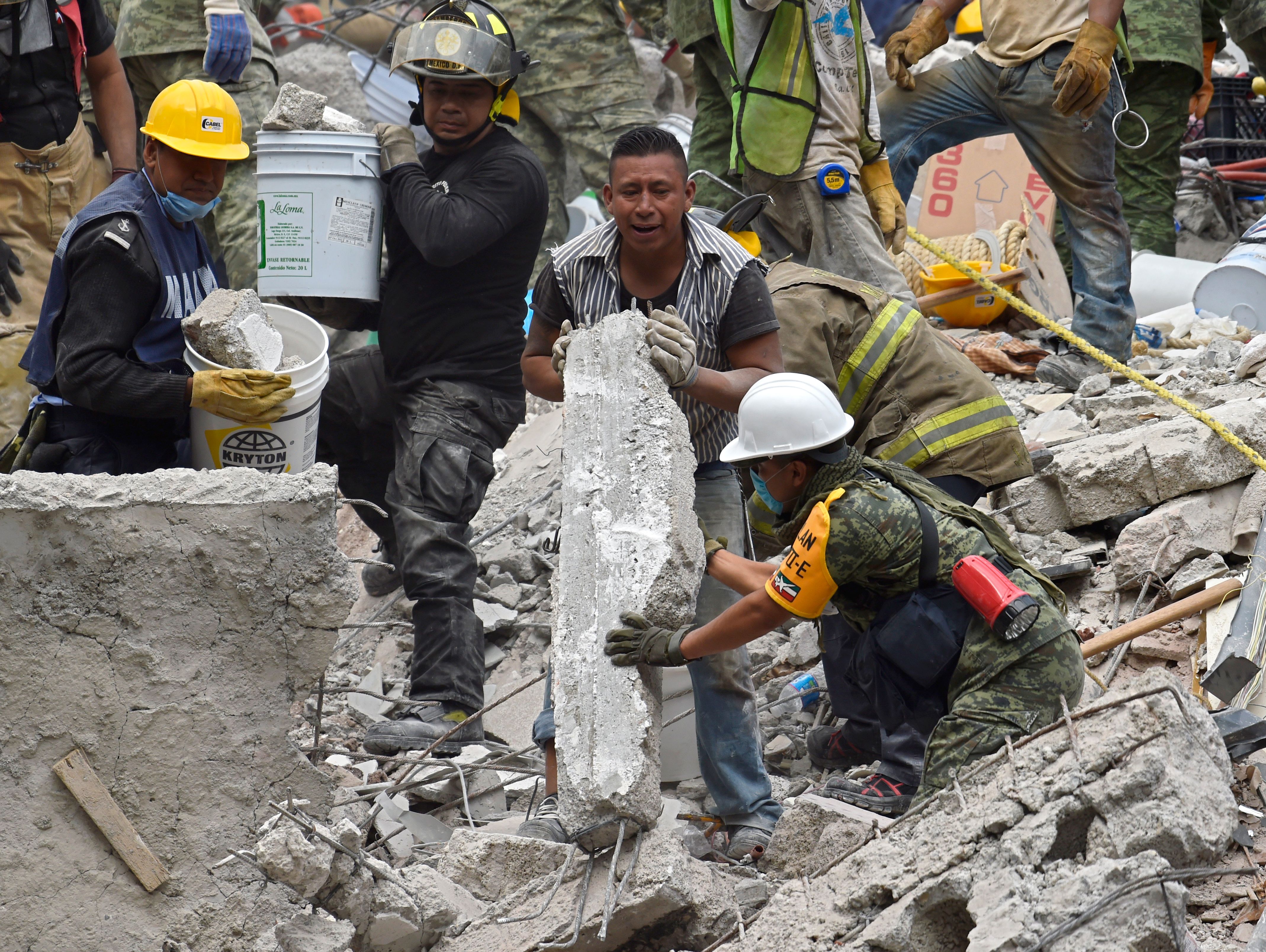 Workers in Mexico dig through rubble left by a powerful earthquake
